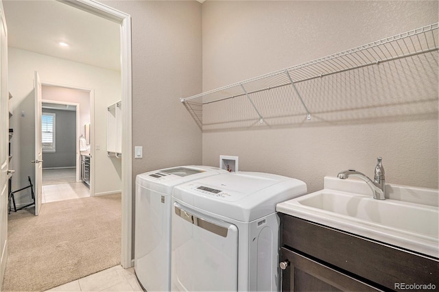 24943 E Phillips Pl, Aurora, CO 80016 - washroom featuring light carpet, washing machine and dryer, a sink, and light tile patterned floors