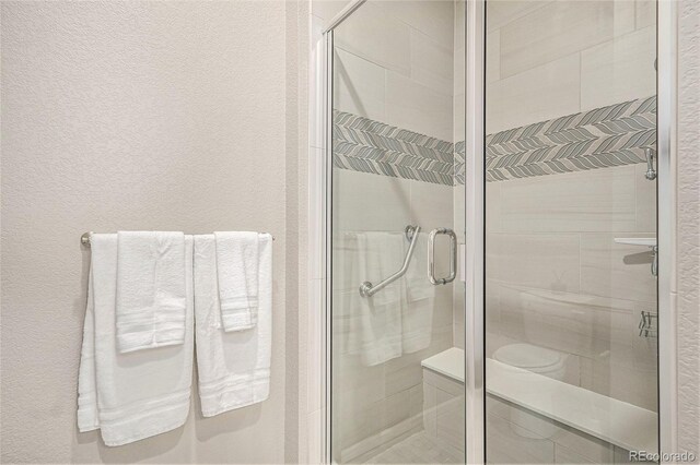 24943 E Phillips Pl, Aurora, CO 80016 - bathroom featuring a shower stall and a textured wall