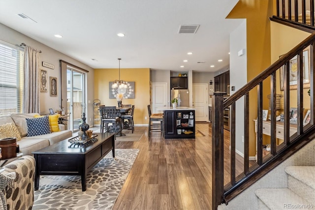 living room featuring hardwood / wood-style flooring and a notable chandelier