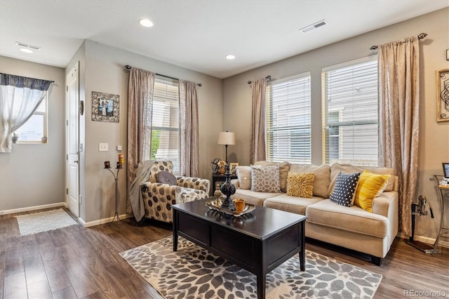 living room with dark hardwood / wood-style floors and plenty of natural light