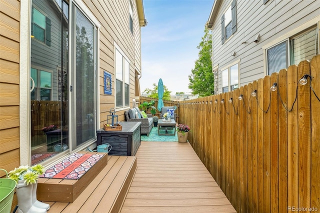 wooden terrace featuring outdoor lounge area