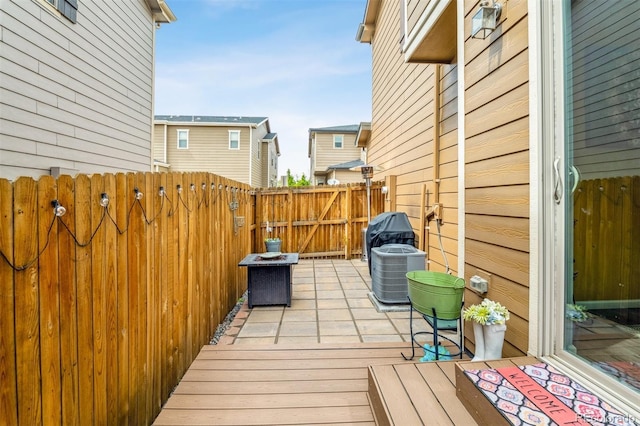 wooden deck featuring central air condition unit