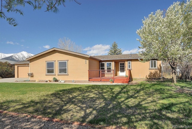 164 Robert Dr, Buena Vista, CO 81211 - single story home with a front yard, a garage, concrete driveway, and a deck with mountain view