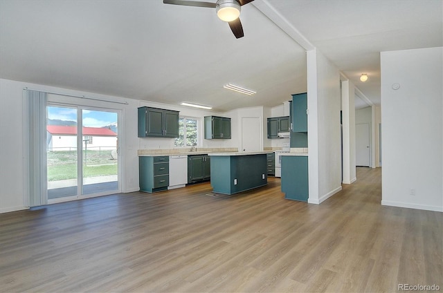 164 Robert Dr, Buena Vista, CO 81211 - kitchen featuring white dishwasher, a kitchen island, light countertops, wood finished floors, and healthy amount of natural light
