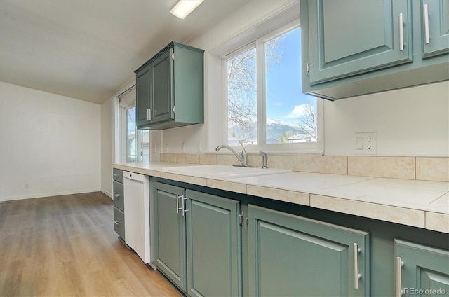 164 Robert Dr, Buena Vista, CO 81211 - kitchen with a sink, white dishwasher, light wood finished floors, light countertops, and baseboards