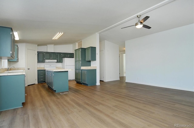 164 Robert Dr, Buena Vista, CO 81211 - kitchen featuring freestanding refrigerator, a sink, dark wood-style floors, and a kitchen island