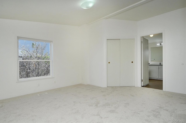 164 Robert Dr, Buena Vista, CO 81211 - unfurnished bedroom with carpet flooring, connected bathroom, and a closet