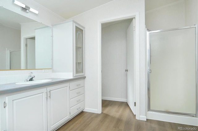 164 Robert Dr, Buena Vista, CO 81211 - full bathroom featuring wood finished floors, a stall shower, vanity, crown molding, and baseboards