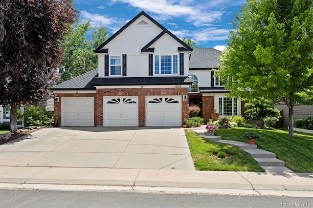 16268 E Belleview Dr, Centennial, CO 80015 - view of front of house with brick siding, driveway, a garage, and a front lawn