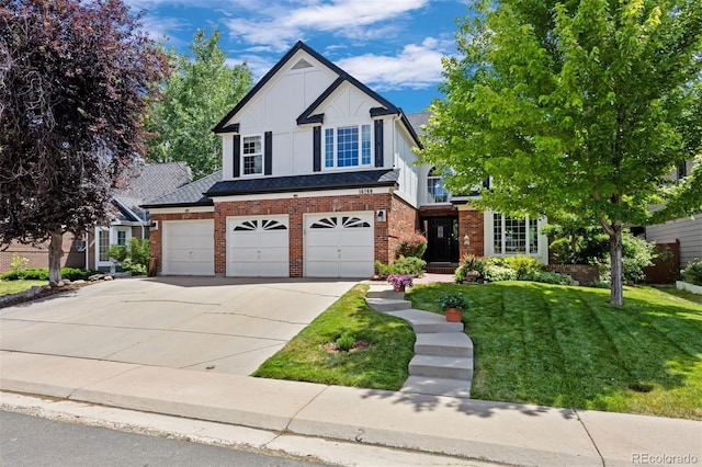16268 E Belleview Dr, Centennial, CO 80015 - view of front facade featuring driveway, a front yard, brick siding, and an attached garage