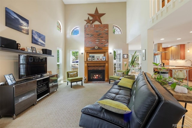 16268 E Belleview Dr, Centennial, CO 80015 - living area with a high ceiling, a fireplace, and light carpet