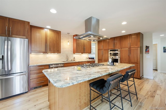 16268 E Belleview Dr, Centennial, CO 80015 - kitchen featuring stainless steel appliances, island exhaust hood, light wood-style flooring, a kitchen island, and recessed lighting
