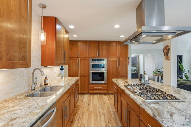 16268 E Belleview Dr, Centennial, CO 80015 - kitchen featuring island range hood, stainless steel appliances, light wood finished floors, brown cabinetry, and light stone countertops
