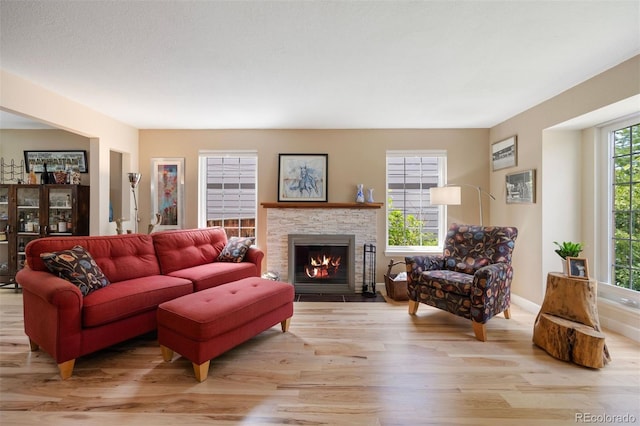 16268 E Belleview Dr, Centennial, CO 80015 - living area featuring light wood finished floors and a fireplace with flush hearth