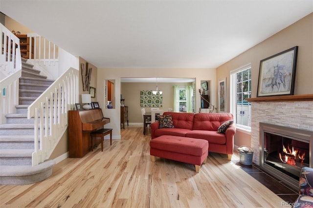 16268 E Belleview Dr, Centennial, CO 80015 - living area featuring wood finished floors, stairs, a chandelier, and a stone fireplace