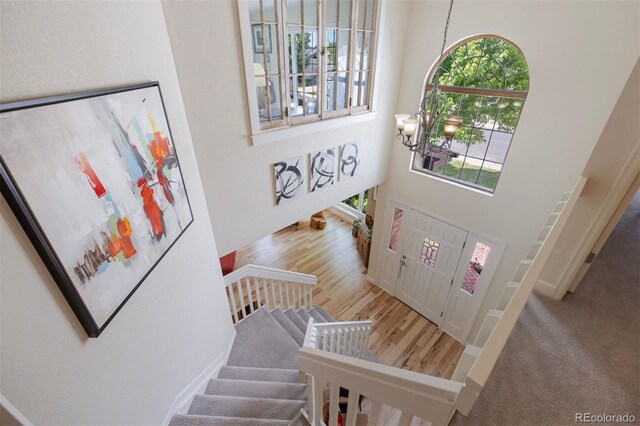 16268 E Belleview Dr, Centennial, CO 80015 - entrance foyer featuring a high ceiling, stairway, and wood finished floors