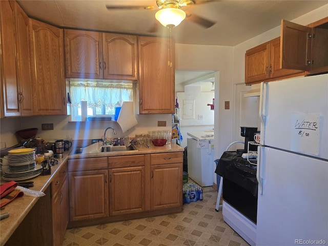 1215 E 7th St, Trinidad, CO 81082 - kitchen featuring freestanding refrigerator, a ceiling fan, stove, brown cabinets, and light countertops