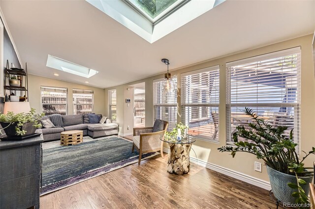 2684 S Adams St, Denver, CO 80210 - living room with a skylight, wood finished floors, vaulted ceiling, and baseboards