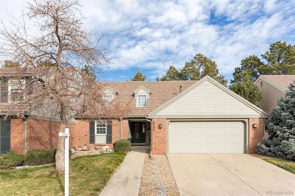 view of front of property with a front lawn and a garage