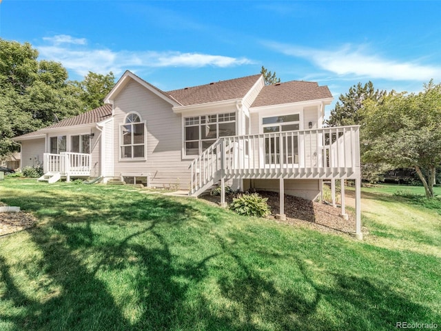 rear view of property with a yard and a deck