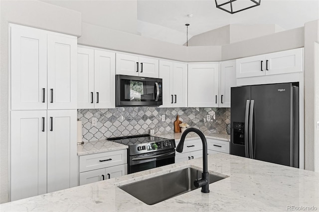 kitchen featuring stainless steel appliances, tasteful backsplash, and light stone counters