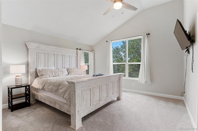 bedroom with ceiling fan, vaulted ceiling, and light carpet