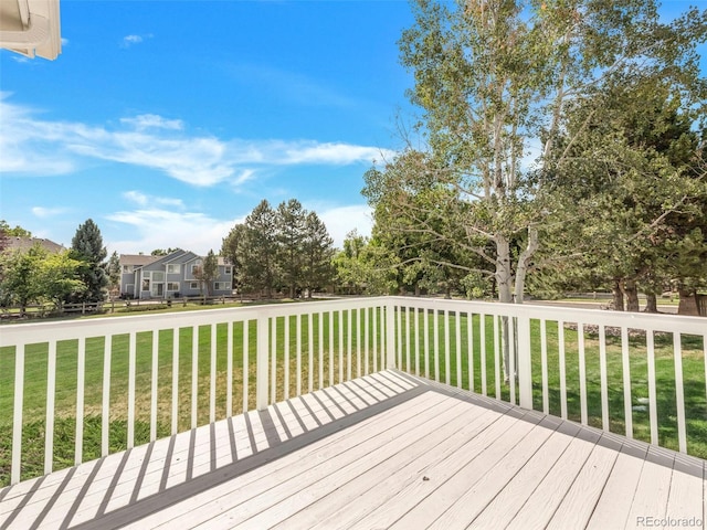 wooden deck featuring a yard