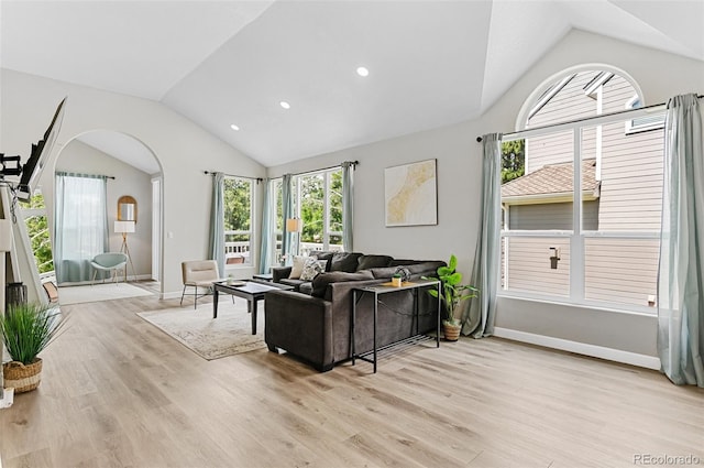 living room with vaulted ceiling and light hardwood / wood-style flooring