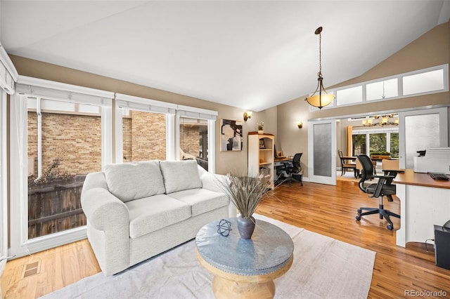 7717 S Grape Ct, Centennial, CO 80122 - living area with lofted ceiling, an office area, and wood finished floors