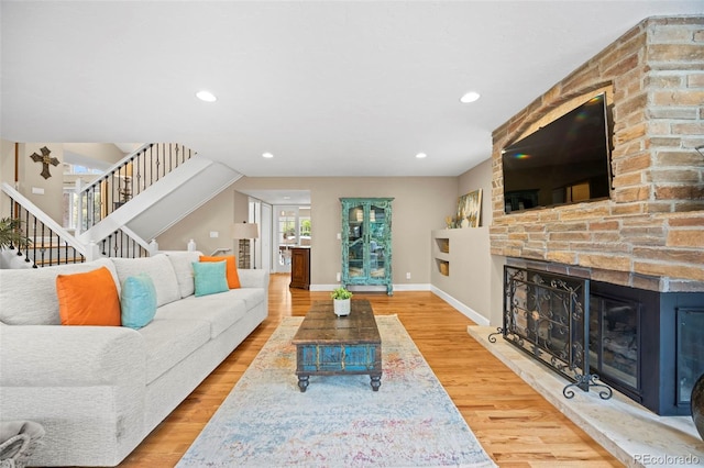 7717 S Grape Ct, Centennial, CO 80122 - living room featuring stairway, a fireplace, baseboards, wood finished floors, and recessed lighting