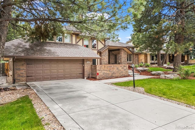 7717 S Grape Ct, Centennial, CO 80122 - tudor-style house with concrete driveway, a front lawn, brick siding, and an attached garage