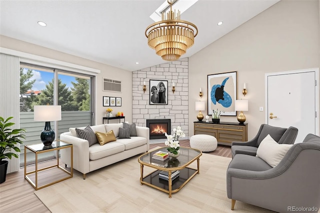 living area featuring vaulted ceiling, a chandelier, a stone fireplace, wood finished floors, and recessed lighting