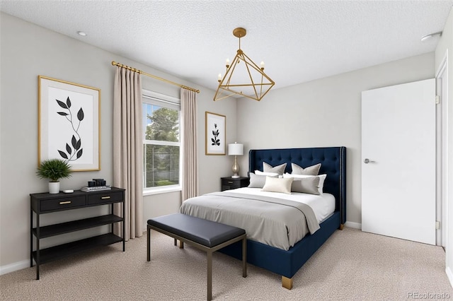 carpeted bedroom featuring a chandelier, a textured ceiling, and baseboards