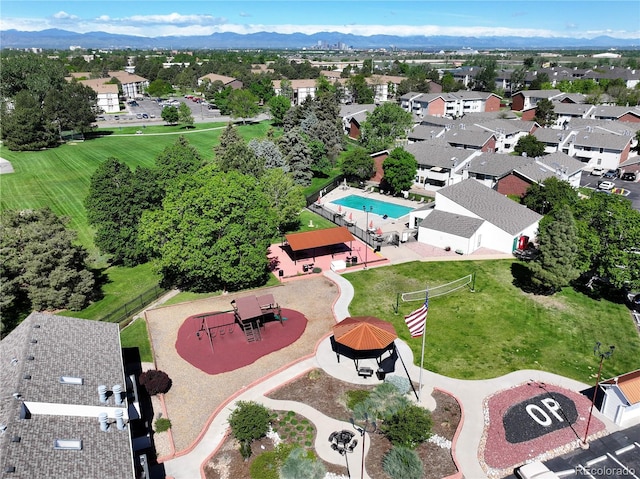 aerial perspective of suburban area with mountains and a pool area