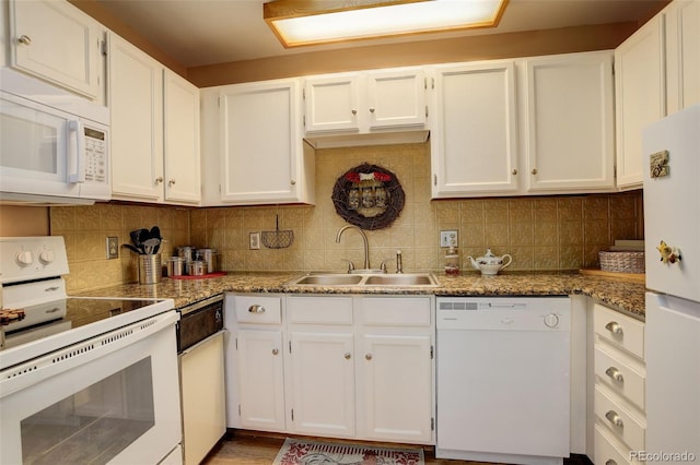 kitchen with a sink, white cabinets, white appliances, and decorative backsplash