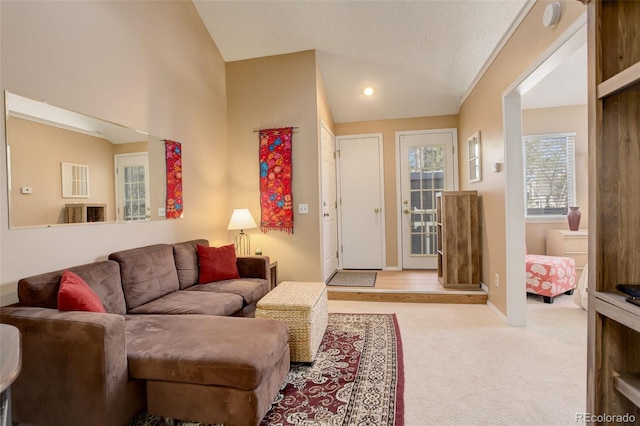 carpeted living room featuring baseboards and vaulted ceiling
