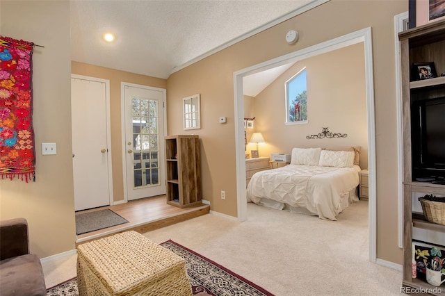 carpeted bedroom featuring baseboards, a textured ceiling, and lofted ceiling