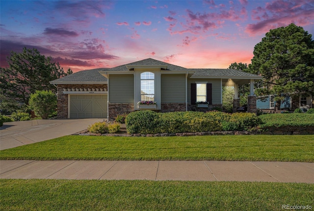 16929 W 63rd Ln, Golden, CO 80403 - view of front facade featuring an attached garage, stone siding, concrete driveway, and a front lawn