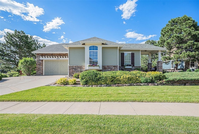 16929 W 63rd Ln, Golden, CO 80403 - view of front of home with an attached garage, concrete driveway, a front yard, stone siding, and a shingled roof