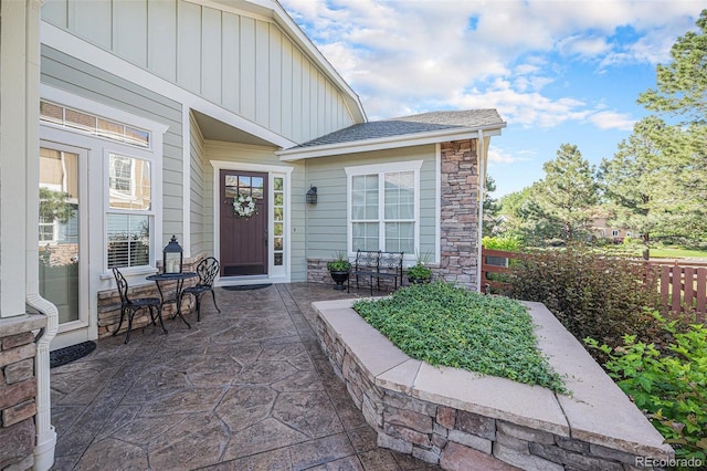 16929 W 63rd Ln, Golden, CO 80403 - entrance to property with board and batten siding, stone siding, and a patio