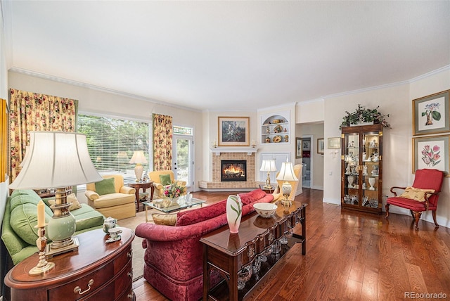 16929 W 63rd Ln, Golden, CO 80403 - living area featuring wood finished floors, ornamental molding, a brick fireplace, and built in shelves