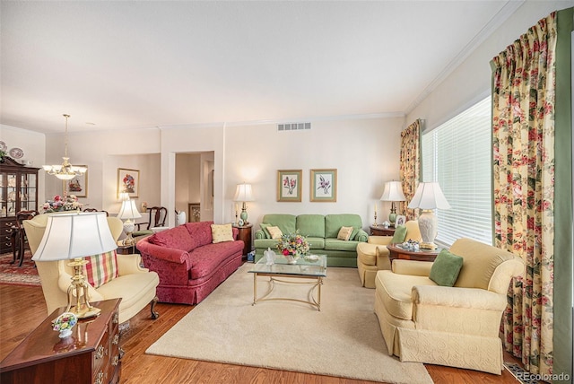 16929 W 63rd Ln, Golden, CO 80403 - living room featuring ornamental molding, a chandelier, and wood finished floors