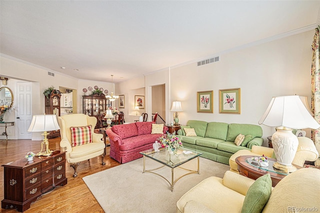 16929 W 63rd Ln, Golden, CO 80403 - living room with a chandelier, crown molding, and wood finished floors