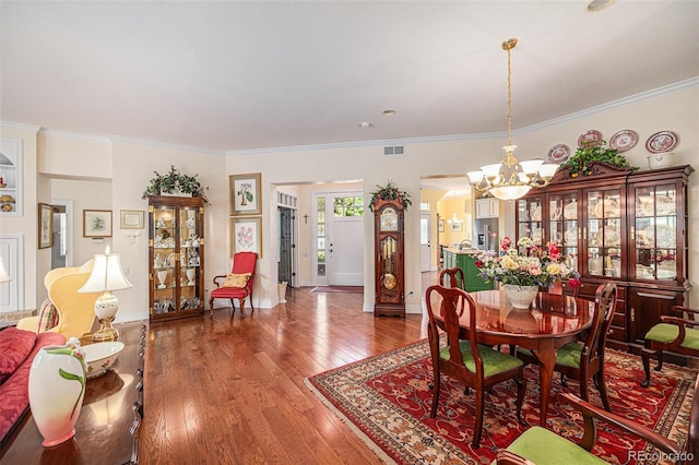 16929 W 63rd Ln, Golden, CO 80403 - dining space with a chandelier, hardwood / wood-style flooring, and ornamental molding