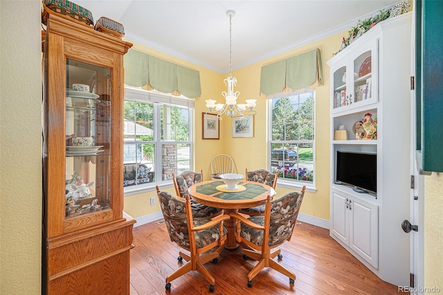 16929 W 63rd Ln, Golden, CO 80403 - dining room with ornamental molding, light wood finished floors, and a chandelier