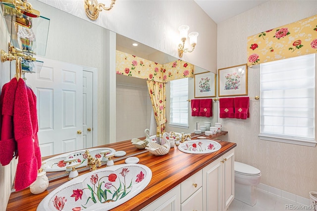 16929 W 63rd Ln, Golden, CO 80403 - full bath with wallpapered walls, double vanity, and tile patterned flooring