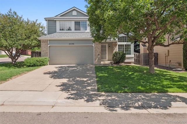 20396 E Berry Pl, Centennial, CO 80015 - view of front of home featuring brick siding, a garage, a front yard, driveway, and a shingled roof