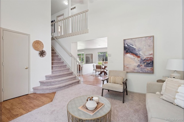 20396 E Berry Pl, Centennial, CO 80015 - carpeted living room with stairway, a towering ceiling, and wood finished floors