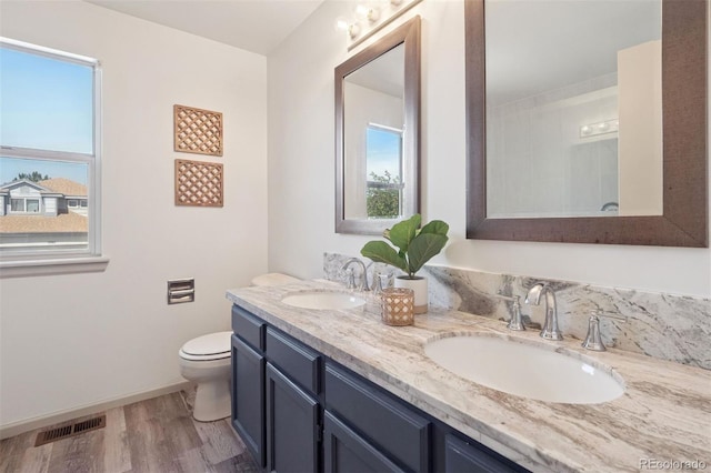 20396 E Berry Pl, Centennial, CO 80015 - full bathroom with double vanity, wood finished floors, and healthy amount of natural light