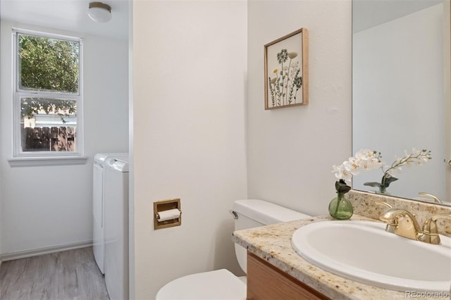 20396 E Berry Pl, Centennial, CO 80015 - half bath featuring washing machine and clothes dryer, vanity, and wood finished floors